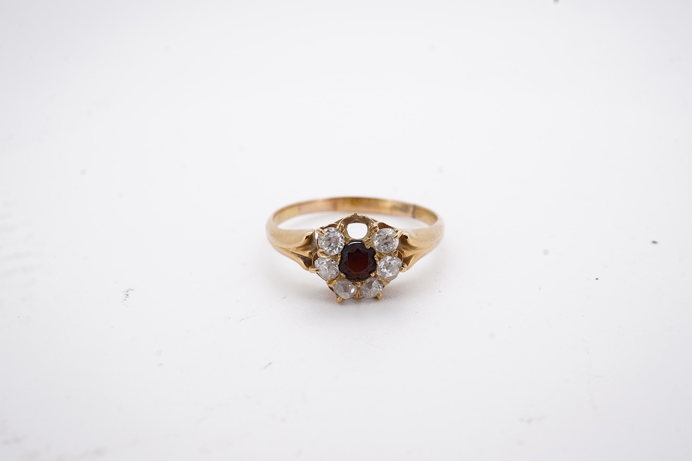 A yellow metal, garnet? and diamond set circular cluster ring (one stone missing), size P, gross weight 3 grams. Condition - poor